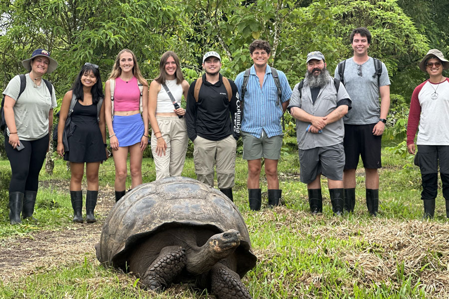 Dr. Michael Muehlenbein and Baylor anthropology students pose with a friend in the Galapagos Islands