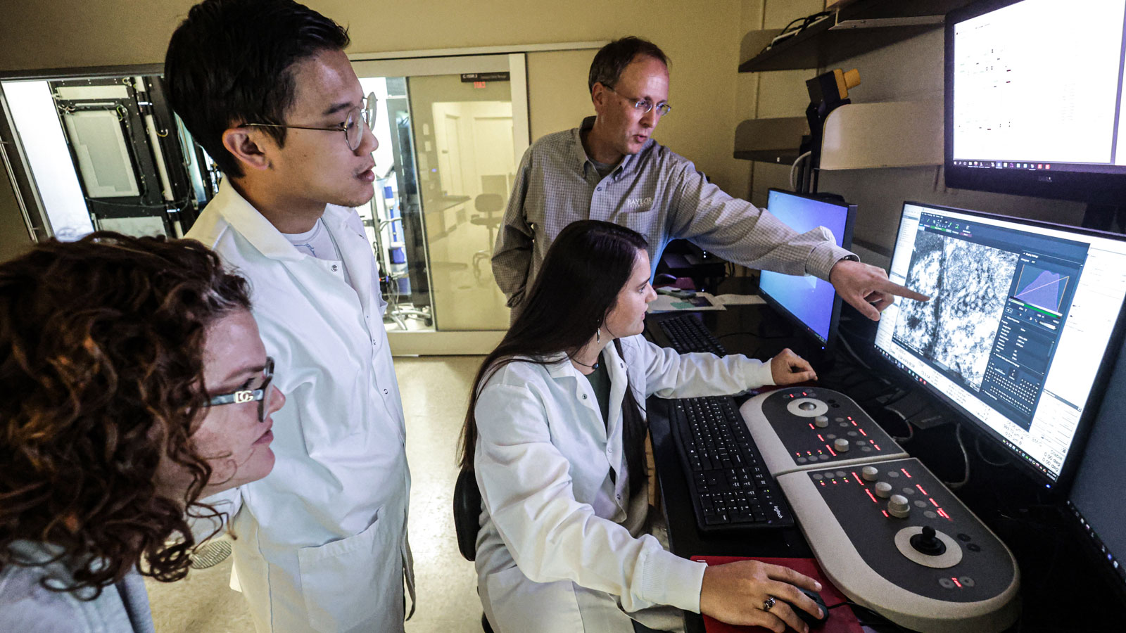 Dr. Bernd Zechmann works with faculty and students to operate Baylor's new transmission electron microscope.