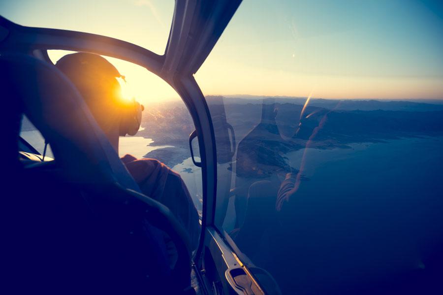 View from the cockpit of a small plane at sunset